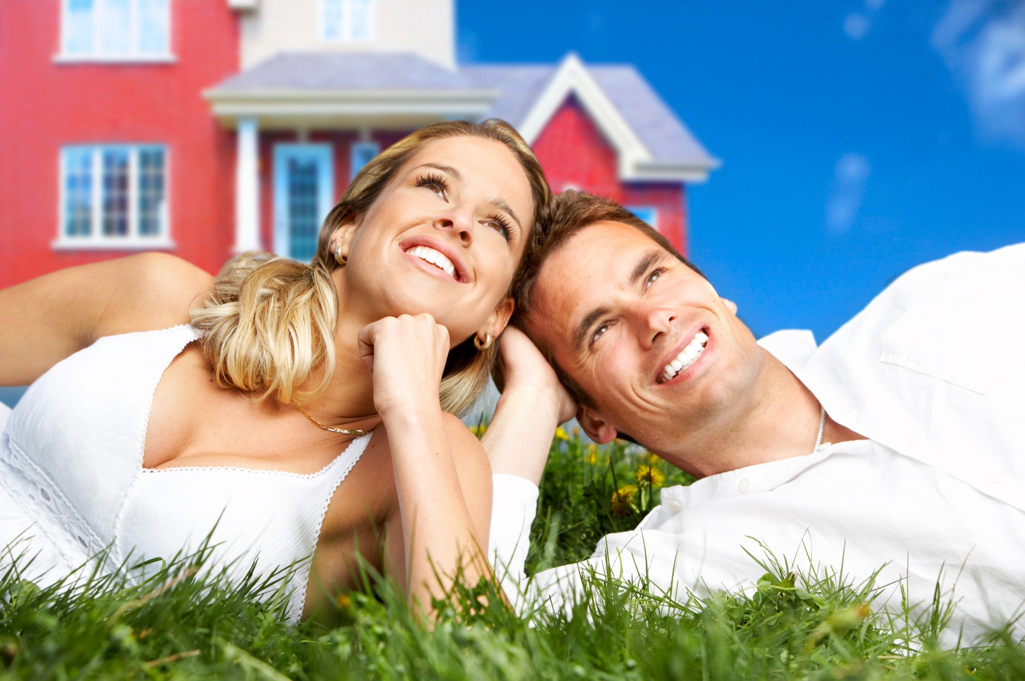 Young love couple smiling dreaming about a new home. Real estate concept