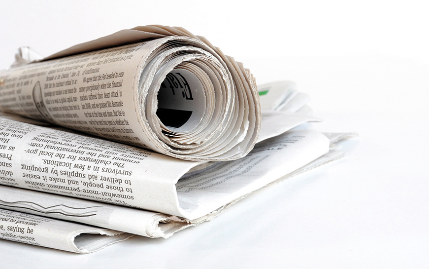 pile of old newspaper on a white background