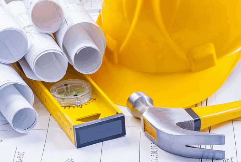 Bauunterlagen, Helm und Hammer als Symbole für Renovierung