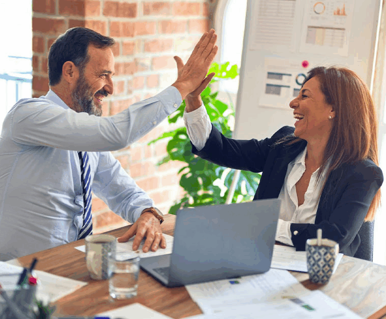 Zwei Menschen die sich nach einer erfolgreichen Entscheidung freudig abklatschen